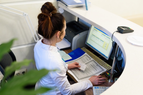 Female receptionist holding business card (photo)